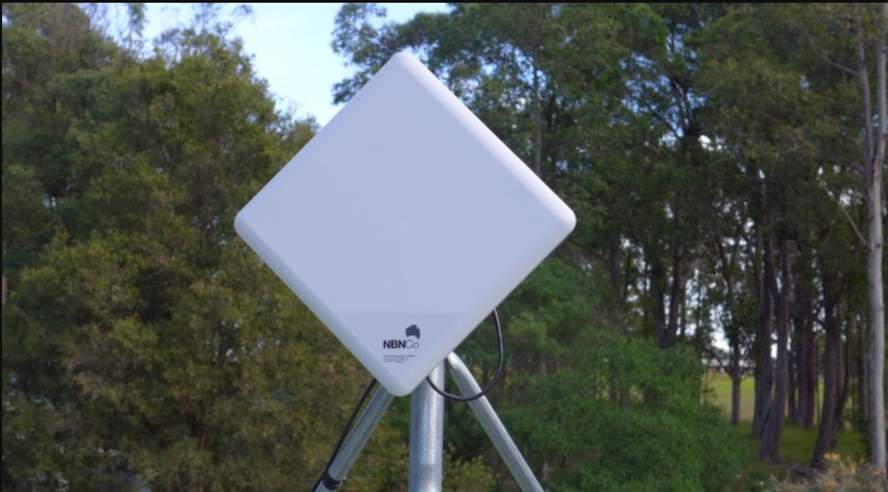 White diamond-shaped NBN Fixed Wireless antenna installed outdoors